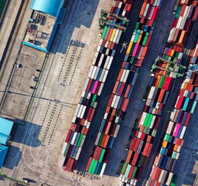 Colourful shipping containers stacked at a port terminal